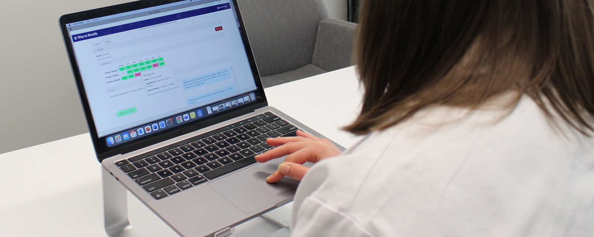 Clinician reviewing patient-reported output data on a laptop